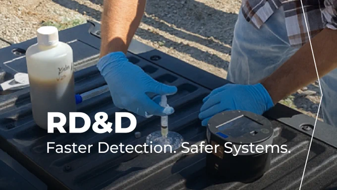 Someone doing n experiment with text that reads "RD&D Faster detection. safer systems"