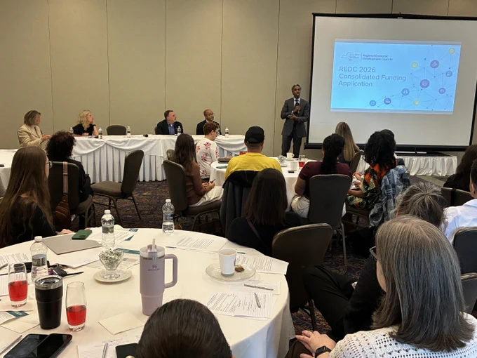 An image of ESD's Small Business representatives speaking to a full room about different funding opportunities.