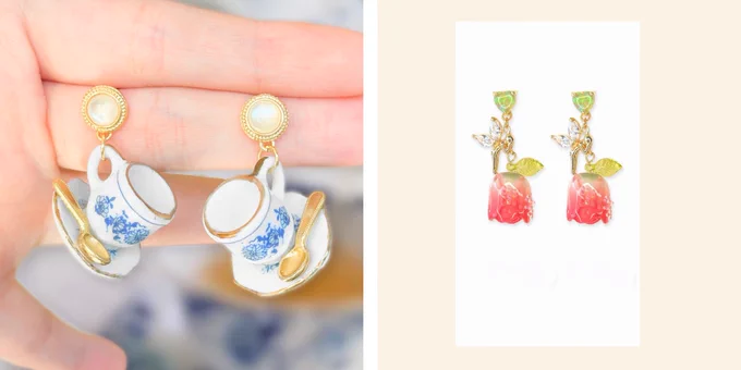 on the left is teacup earrings with pearl studs. hanging from the studs is a mini blue china teacup pattern cup and saucer with a little spoon on the plate. on the right is earrings with a green opal stud and hanging from it is a crystal fairy and a real looking leaf/tulip bead.