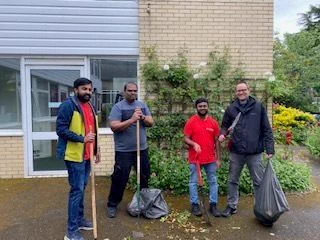 Group of volunteers stand smiling outside Sutton Vision offices