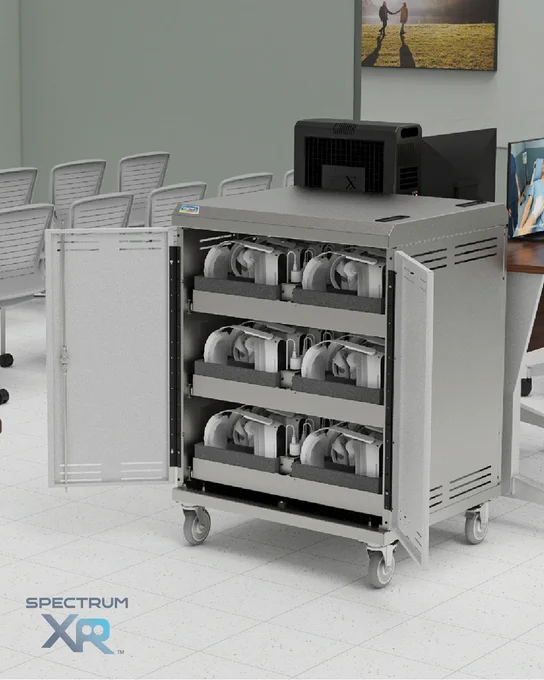 Lab setting with a steel VR charging cart; doors open to three foam-lined drawers charging multiple headsets.