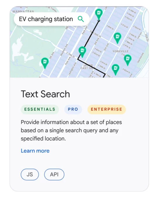 A feature card for "Text Search" showing a map with "EV charging station" search results and several green pins. The text below identifies the feature's tiers—ESSENTIALS, PRO, and ENTERPRISE—and describes its function to provide place information based on a search query and location, with "JS" and "API" labels at the bottom.