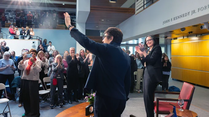 Billy Jean King waves to the audiences as they cheer for her in the forum.