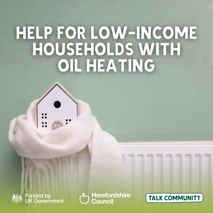 Help for low-income households with oil heating, featuring a model house wrapped in a scarf on a radiator.