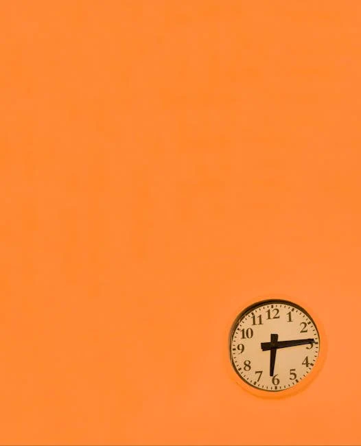 A minimalist wall clock set against an orange background. Captures time simplicity.