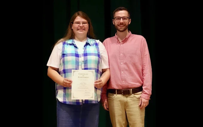 Haley Jones, a graduating senior at Harlan High School (Harlan Independent), left, was awarded the district’s first GoTeach Scholarship. Tyler Saylor, right, an English language arts and Senior Seminar instructor at Harlan High School, created the scholarship in partnership with two local businesses to encourage and support future educators in Kentucky.