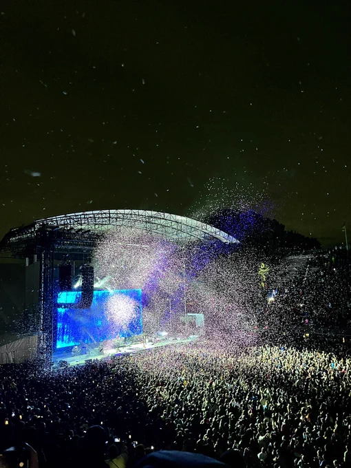 Forest Hills Stadium in the evening, with confetti released into the air.