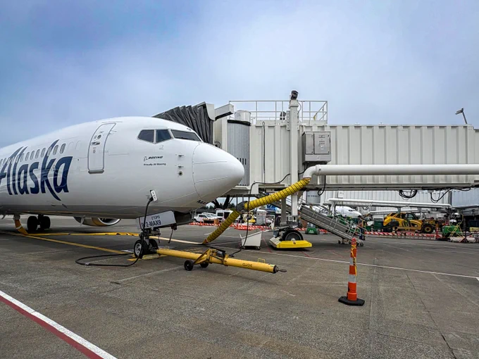 Close-up of a passenger loading bridge installed by PCL Construction connecting to an aircraft at Seattle Tacoma International Airport in Seattle, Washington.
