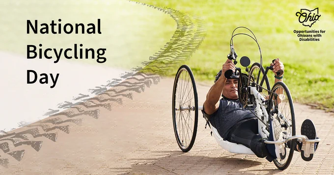 A man rides an accessible bike on a brick path. An illustration of a tire track overlays the photo. Text, "National Bicycling Day." OOD logo.