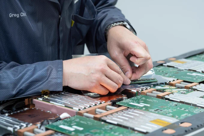 Greg Chow removes components from a module of the Athena modular supercomputer in the Modular Supercomputing Facility (MSF) in R&D99.
