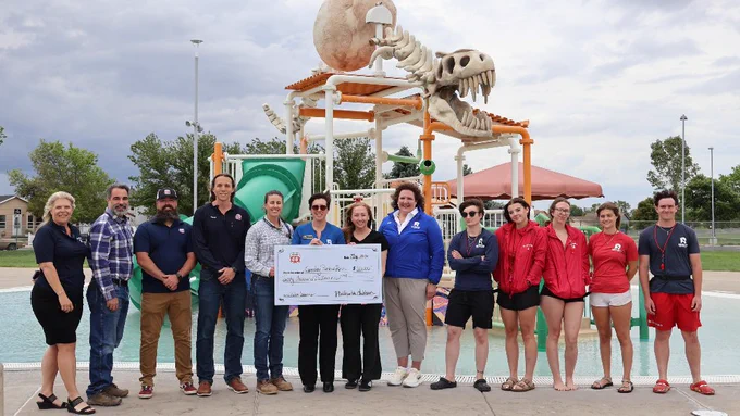Employees with Phillips 66 Mainstream and Greeley Recreation pose at Discovery Bay Waterpark with an oversized check given to the City of Greeley for swim lesson access for those in need. 