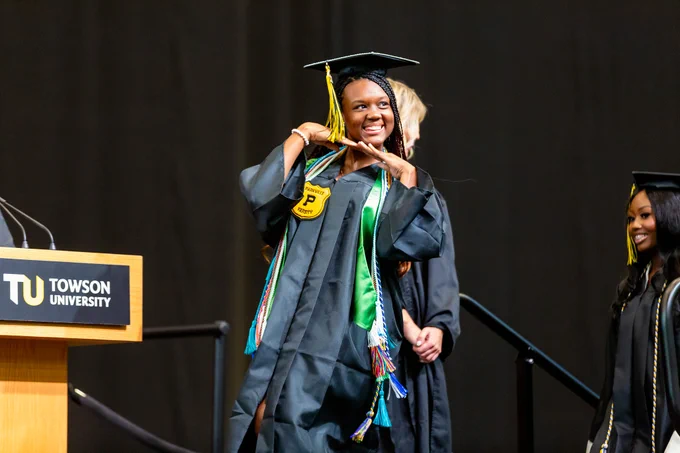 Photo of a smiling graduate at the ceremony.