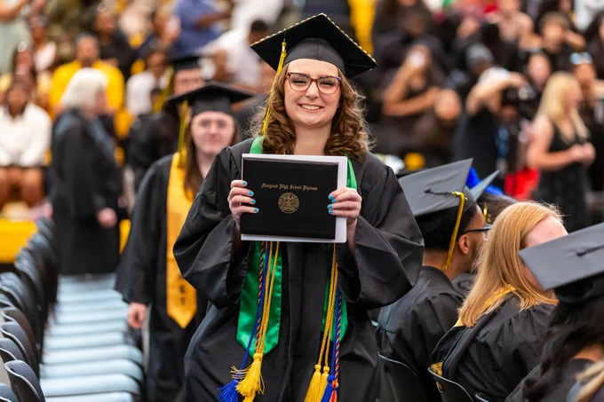 Photo of a smiling graduate at the ceremony.