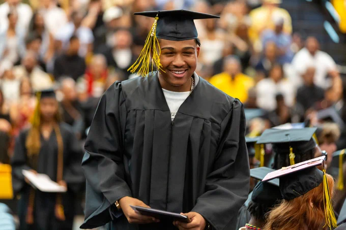 Photo of a smiling graduate at the ceremony.