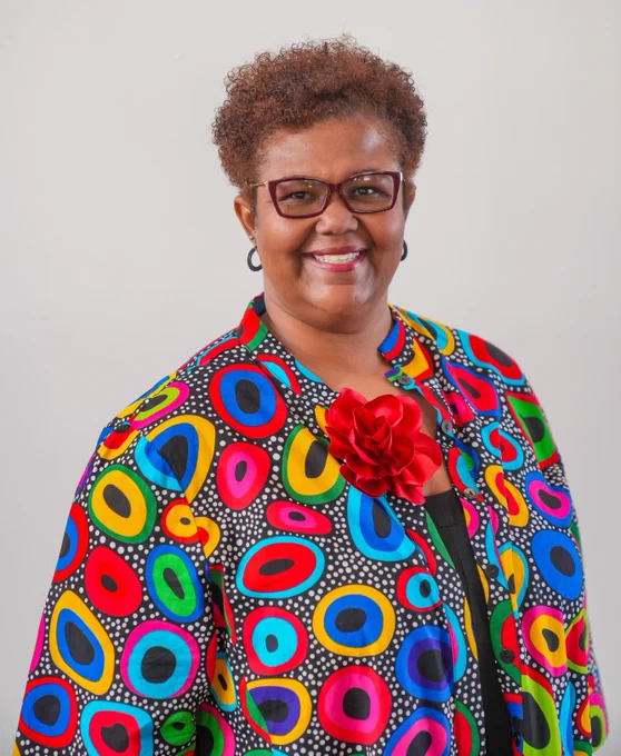 Recipient of the 2025 Robert B. Downs Intellectual Freedom Award Nicole A. Cooke smiles while wearing a colorful jacket.