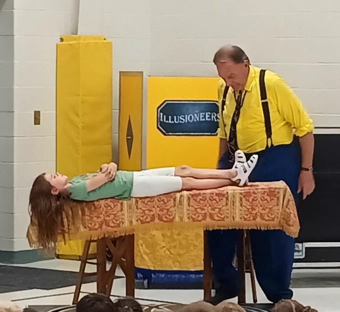 Student "levitating" during magician act