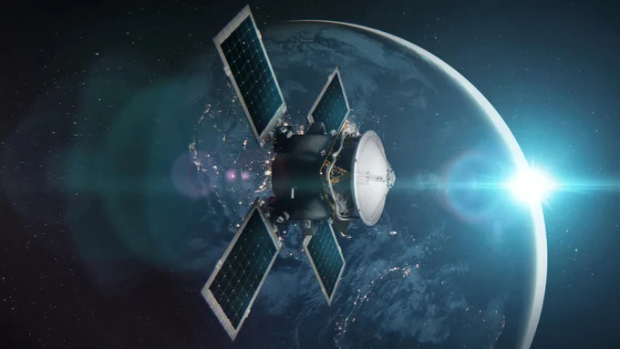 -A near-profile 3D rendering of the Polylingual Experimental Terminal (PExT) orbiting Earth. The satellite’s four deep teal solar panels extend in an X-shape, and its white parabolic antenna dish faces to the right. Metallic gold and silver wires and structural hardware are visible between the dish and its metal satellite bus. In the background, bright sunlight partially illuminates the right side of the Earth’s surface, while the darker left hemisphere is dotted with clusters of glowing yellow city lights.

Image Credit: NASA/Dave Ryan