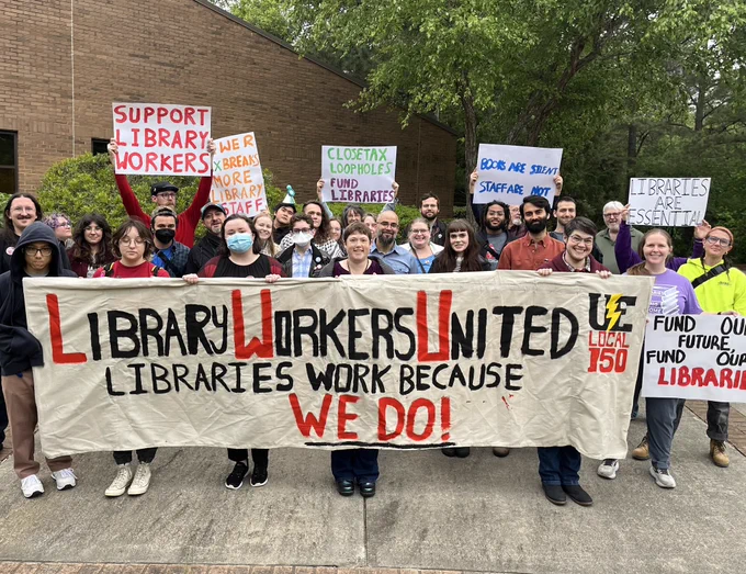 Library Workers United banner held by the union members