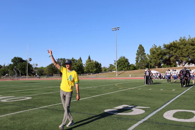 mayor walking on the football field