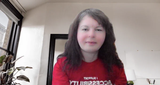 Me wearing a red shirt with white lettering that reads, “I support accessibility, inclusion and equity. Easter Seals Ontario Helping kids with physical disabilities succeed