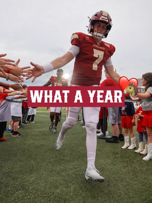 A football player in a red uniform high-fives fans, celebrating after a significant achievement with 'What a Year' text overlay.