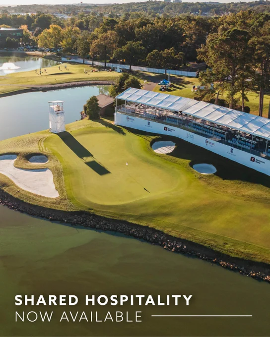 Aerial view of a well-maintained golf course featuring a green, sand traps, and a water hazard. A large hospitality tent is positioned alongside the green. Trees and additional parts of the course are visible in the background. Text at the bottom reads, "Shared Hospitality Now Available.