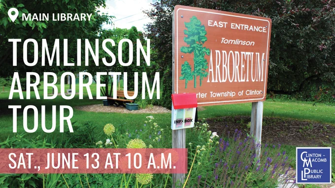 Sign for Tomlinson Arboretum East Entrance surrounded by greenery and flowers under a partly cloudy sky.