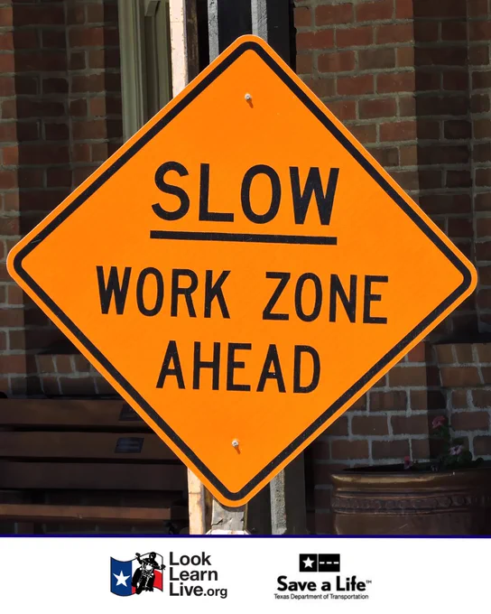 An orange diamond-shaped traffic sign reads "Slow Work Zone Ahead." The sign is posted on a metal pole. Logos for Look Learn Live.org and the Texas Department of Transportation appear at the bottom.