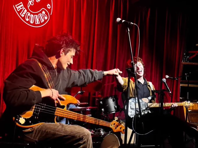 My friend is the one on the left with the bass and that’s me on the right with guitar and we’re fist bumping