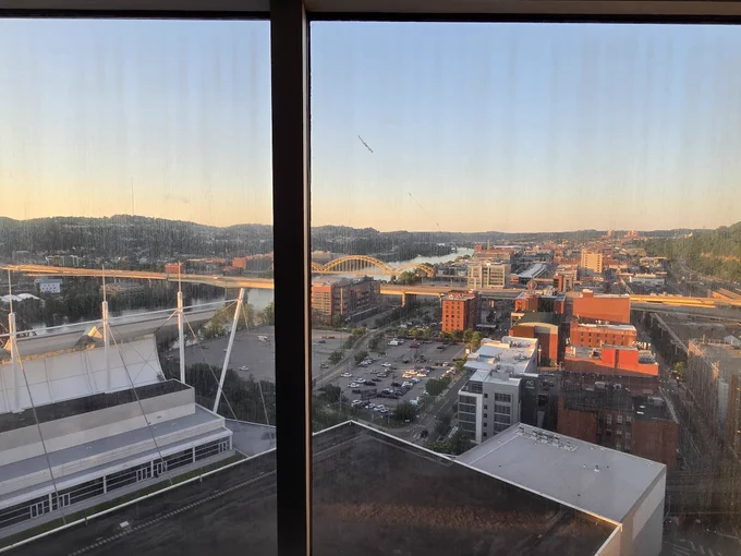 Shot of buildings and hills taken from a hotel room 