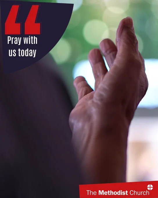 Photo of a hand raised in prayer. Methodist logo in the lower right corner and text which reads 'pray with us today' in the upper left. 