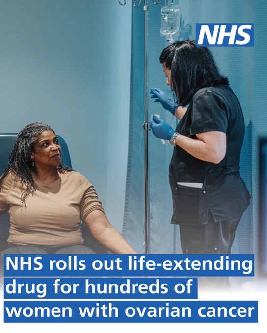 A black senior woman talks with a nurse before as she prepares an IV drip of treatment. Copy reads: 'NHS rolls out life-extending drug for hundreds of women with ovarian cancer.' NHS logo appears in the top right corner.