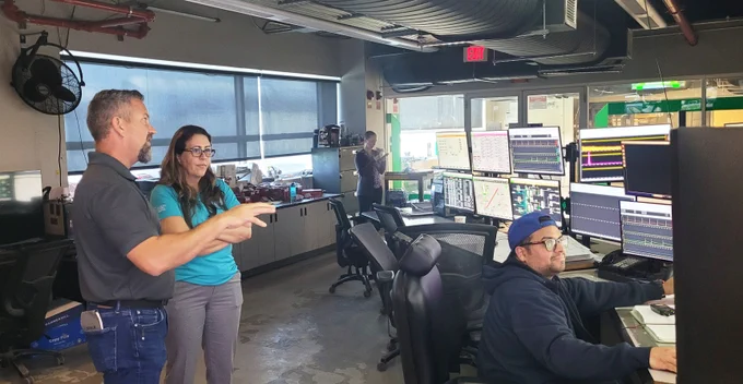 Senior REF Manager Darin Bailey explains the importance of the control room at Renewable Energy Facility 2 to Erica Whitfield. 