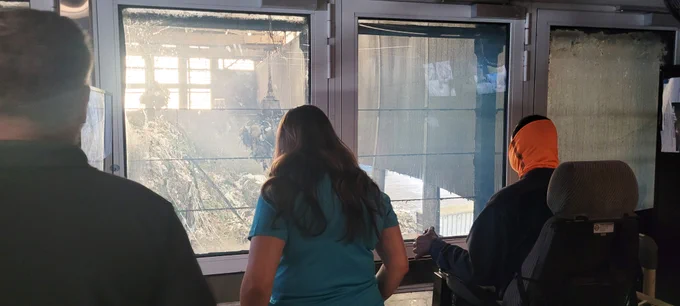 Erica Whitfield watches the claw operator collect garbage from the pit.
