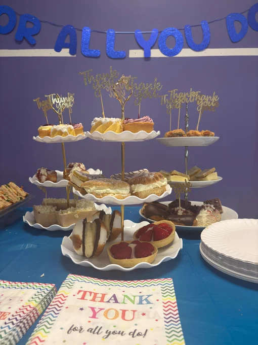 Photo of Volunteers' week tea party with thank you for all you do banner and different cakes