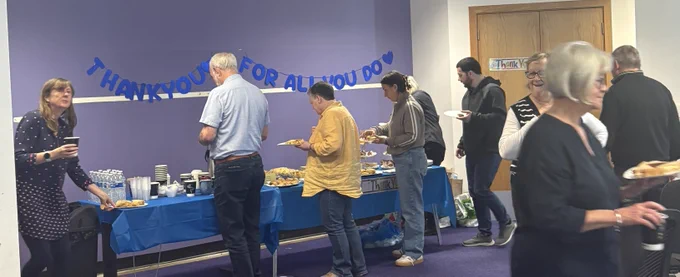 Volunteers and staff at the Volunteers Week tea party enjoying the buffet