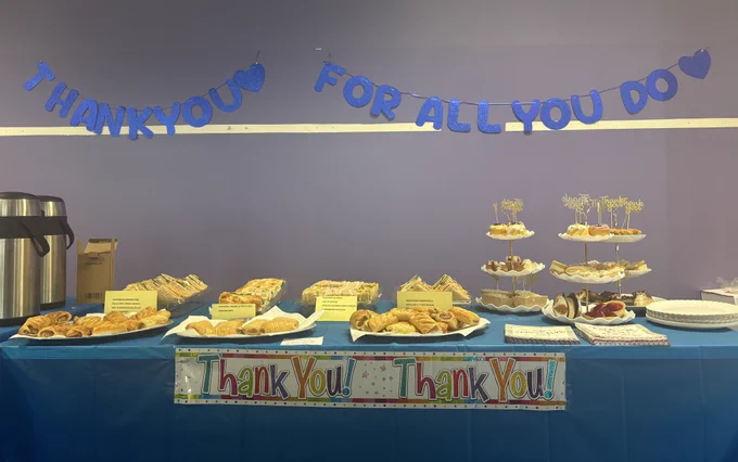 Cakes, coffee, and sandwiches at the Volunteers Week party buffet.
