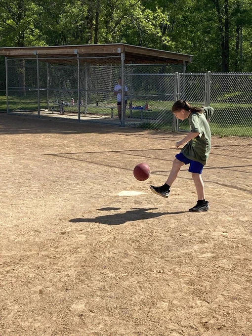 6th grader up at the plate kicking a kick ball