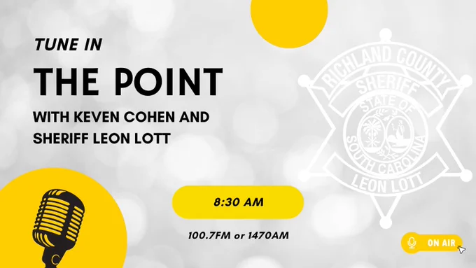 An image promoting a radio show episode featuring Keven Cohen and Sheriff Leon Lott. Text reads: "Tune in The Point with Keven Cohen and Sheriff Leon Lott." The timing is 8:30 AM, airing on 100.7 FM or 1470 AM. The background includes a subtle emblem of Richland County Sheriff’s Department. There are yellow circles and an icon of a microphone and a small "On Air" symbol.