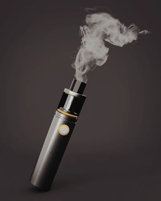 A dark grey e-cigarette with a gold trim, emitting a cloud of white vapour against a dark background.