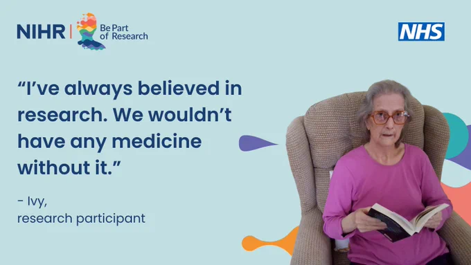 An elderly woman with gray hair and large glasses is seated in an armchair, holding an open book. She wears a bright pink top. To the left is a quote: “I've always believed in research. We wouldn’t have any medicine without it.” At the top left, the NIHR "Be Part of Research" logo is visible, and the NHS logo is at the top right. The background is light blue with colorful abstract shapes.