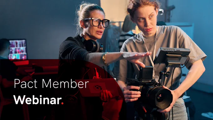 Two people collaborating on a video shoot, one holding a professional camera while the other points beyond it. In the lower left is a semi-opaque curved red overlay with the words 'Pact Member Webinar' in white.