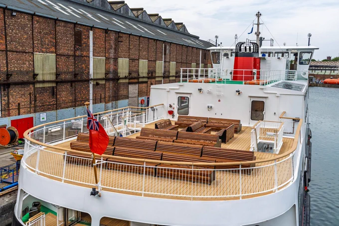 The new ferry will offer a world-class experience, featuring spacious open-plan decks, new seating areas, and vibrant bars where passengers can relax and enjoy stunning views across the River Mersey.