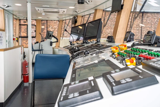 The new ferry will offer a world-class experience, featuring spacious open-plan decks, new seating areas, and vibrant bars where passengers can relax and enjoy stunning views across the River Mersey.