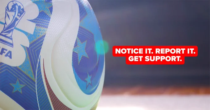 A football with FIFA World Cup branding and the message 'NOTICE IT. REPORT IT. GET SUPPORT.'