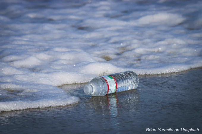 Discarded plastic water bottle in the sea