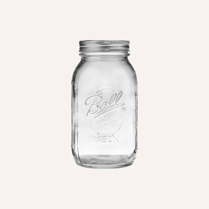A 32 ounce mason jar by Ball, the original canning solution for food preservation using a vacuum seal.
