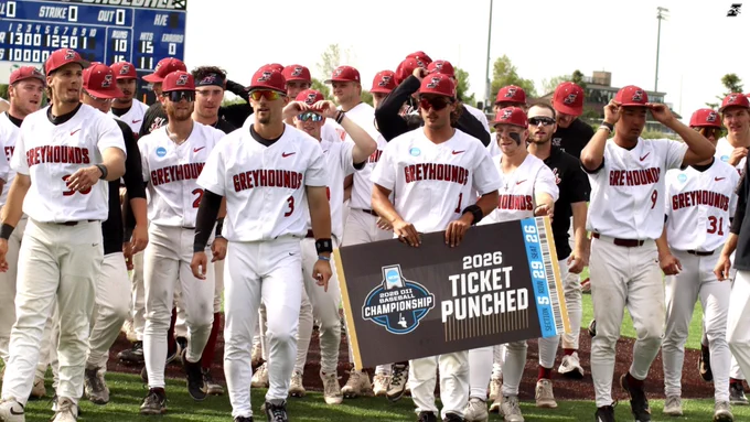 Members of the team walk toward the trophy with the “ticket punched” sign.