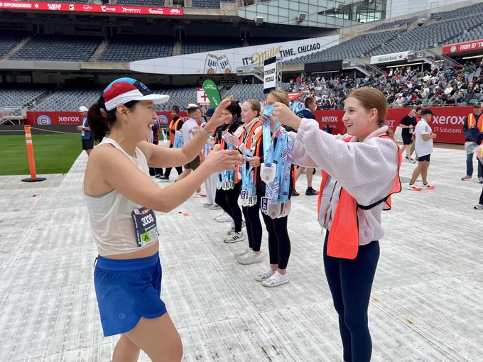 Runner receiving her medal after race