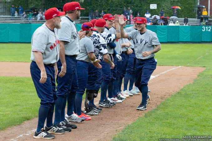 Jake Peavy high-fives teammates on the first base line as he is introduced at the Hall of Fame Military Classic. (Milo Stewart Jr./National Baseball Hall of Fame and Museum)